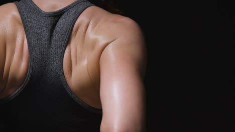 Close-Up-Studio-Shot-Showing-Back-Of-Mature-Woman-Wearing-Gym-Fitness-Clothing-Doing-Stretching-Exercises-2